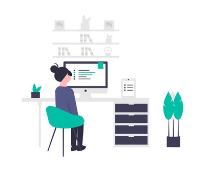 a lady sitting at her workstation (unsplash)