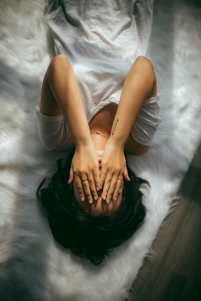 women upset and covering her face